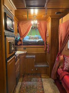 a small bathroom with a sink and a bed at The Pony Experience; Glamping with Private Petting Zoo in Temecula