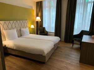 Postel nebo postele na pokoji v ubytování Hotel Au Quartier