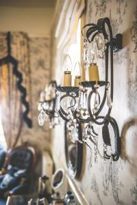 a chandelier hanging from a wall in a room at Jeakes House in Rye