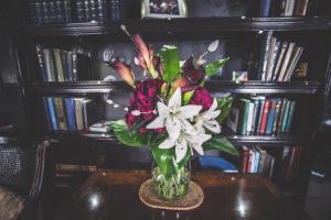 a vase filled with flowers sitting on a table at Jeakes House in Rye