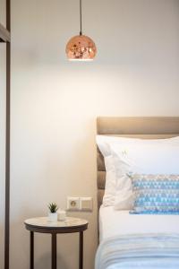 a bedroom with a bed and a table next to it at VagAthan - Lux Holidays in Afitos