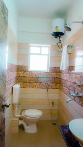 a bathroom with a toilet and a sink at The Bliss in Kolkata