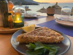 a plate with a piece of food on a table at Molos Beach Rooms in Kissamos +25 photos