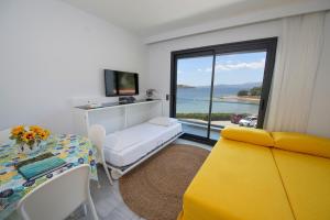 a room with a bed and a table and a window at Mert Otel in Cesme