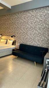 a bedroom with a bed and a brick wall at Agora Studios in Plovdiv