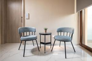 two chairs and a table in a room at VagAthan - Lux Holidays in Afitos