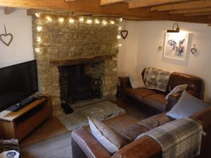 a living room with a couch and a fireplace at 2 Vicarage Lane in Highworth