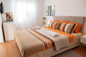 a bedroom with a bed with two towels on it at Apartment and Rooms Vilma in Fažana