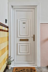 a white door with a handle on it at Bay Apartment in Helensburgh
