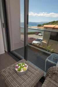 a bowl of salad on a table on a balcony at Mert Otel in Cesme