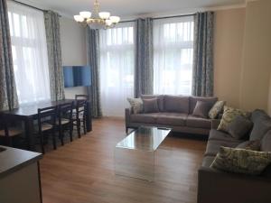 a living room with a couch and a table at Rezidence Beethoven in Karlovy Vary