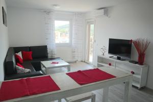 a living room with a couch and a tv at Apartman Lilly in Modriča