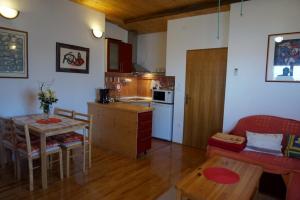 een keuken en een woonkamer met een tafel en een eetkamer bij Apartments Ivanković in Preko