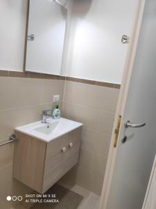 a bathroom with a sink and a mirror at Residenza Marvasi 10 in Caserta