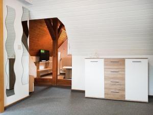 a room with white walls and a room with wooden ceilings at Gästehaus Dietrich in Bad Sooden-Allendorf