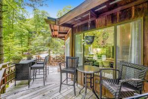 a patio with chairs and a table on a deck at 102 Village Cluster in Beech Mountain