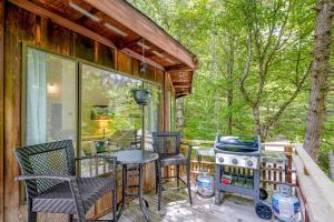 a patio with a table and chairs and a grill at 102 Village Cluster in Beech Mountain