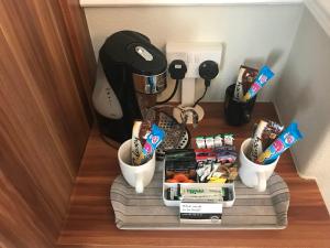 a shelf with food and a coffee maker on a table at Lauriston & Lawton Court Hotel in Llandudno