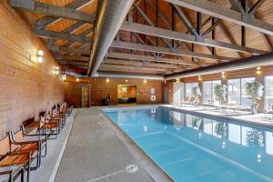 a large swimming pool with chairs and tables at Needles View #11 in Durango Mountain Resort