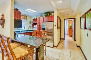 a kitchen with a glass table and wooden chairs at Torres Colina in Escazu