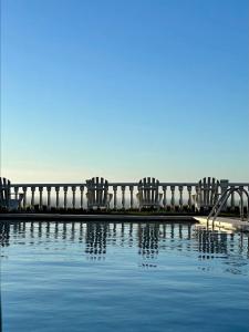 a row of chairs sitting next to a swimming pool at Apartamentos El Caserio in Suances