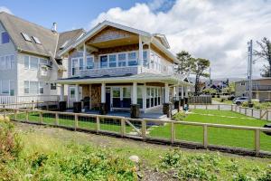 a large white house with a wooden fence at Seaside Refresh in Seaside