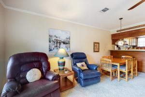 a living room with a couch and chairs and a table at Condo on the Green in Canyon Lake