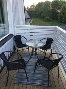 a patio table with chairs and umbrellas at Nebulosavägen 20 in Sundsbruk