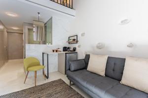 a living room with a couch and a table at Mitos-Suites in Rethymno