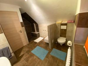 a small bathroom with a toilet and a shower at Ferienwohnung Erfurt Marbacher Höhe in Erfurt +11 photos