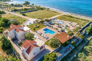 an aerial view of a house with a swimming pool and the ocean at Villa Mis in Supetar