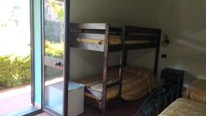 two bunk beds in a room with a window at Agriturismo Il Pozzo Antico in Mascali
