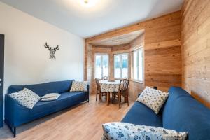 a living room with a blue couch and a table at -Antermoia- Appartament Canazei Center in Canazei