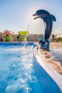 a dolphin fountain in a swimming pool at Villa Mis in Supetar