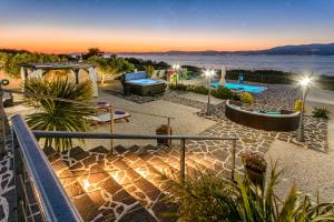 a patio with a view of the water at night at Villa Mis in Supetar