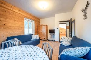 a living room with a blue couch and a table at -Antermoia- Appartament Canazei Center in Canazei