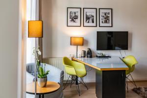 a hotel room with a desk with a tv and chairs at Boutique-Hotel Villa Anna in Eisenach