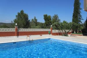 una piscina frente a una casa en Lovely studio, terrace, swim pool, nature, relax!!, en Sant Pere de Ribes