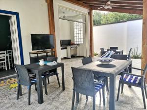 a living room with a table and chairs and a television at La Casa di Anna in Palmi