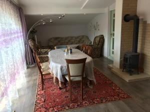 a dining room with a table and a fireplace at Sea & BBQ apartment , 2nd floor in Liepāja +20 photos