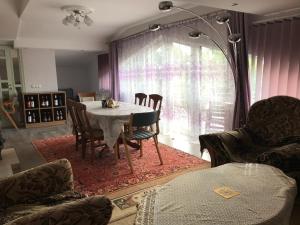 a dining room with a table and chairs at Sea & BBQ apartment , 2nd floor in Liepāja