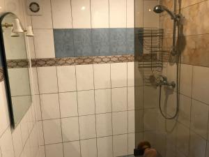 a bathroom with a shower with a glass door at Sea & BBQ apartment , 2nd floor in Liepāja