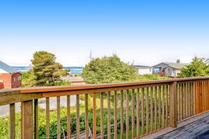a wooden deck with a view of a yard at Bayocean Retreat in Cape Meares +21 photos