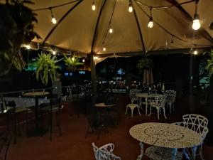 a restaurant with tables and chairs and lights at Hospedaje Del Campanero 19 in Guanajuato