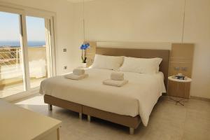 a bedroom with a large bed with a large window at Bizantini Tropea in Tropea