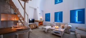 a living room with a couch and a table with candles at MyBozer Twin Villas Heated Private pools All Year in Foinikiá