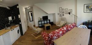 sala de estar con sofá rojo y cocina en Apartamento Sebreñu 2, en Ribadesella