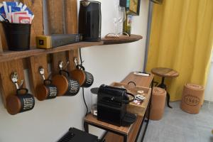 a room with wooden shelves with coffee mugs at AMARE IL MARE Affittacamere e appartamenti in Corniglia