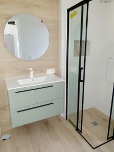 uma casa de banho com um lavatório e um espelho em Penthouse Haramara, Romana Playa Marbella em Marbella