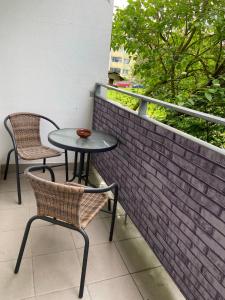 a table and two chairs sitting on a balcony at Apartment Fialka in Olomouc